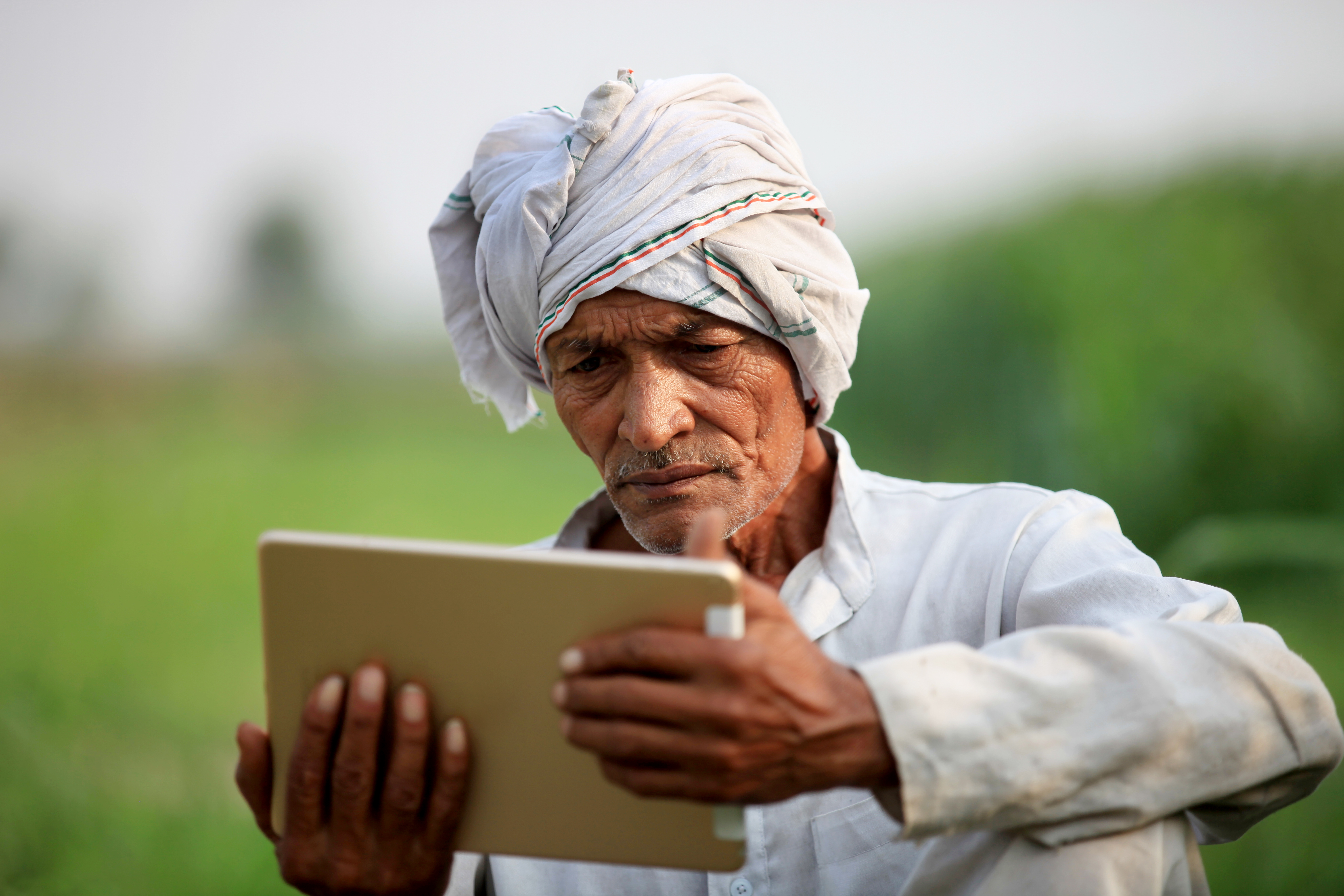 Man reading a Bible on an ipad.