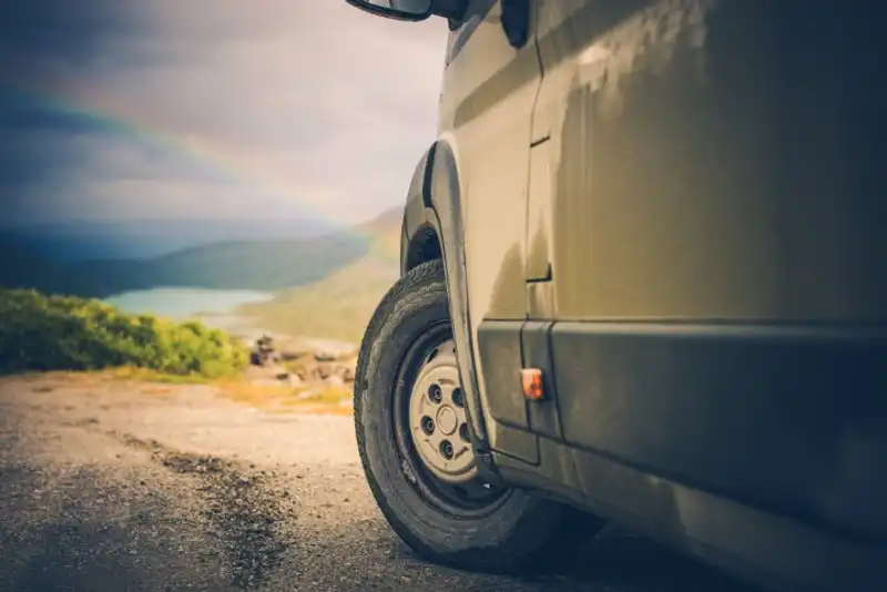 An RV on a dirt road.