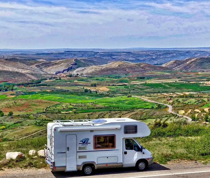 White RV overlooking mountains